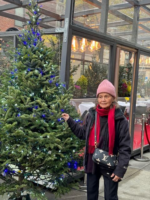 Connie by a Christmas tree